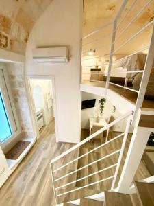 a staircase in a room with a bed and a bedroom at Stella Marina Luxury in Polignano a Mare