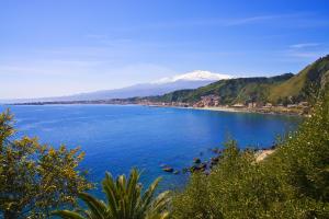 a view of a large body of water with a snow covered mountain at Casa Mare in Giardini Naxos
