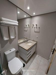 a bathroom with a toilet and a sink and a mirror at Bienal Ibirapuera in Sao Paulo