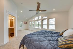 a bedroom with a large bed and windows at Lakefront Burlington Vacation Rental Dock and Beach in Twin Lakes