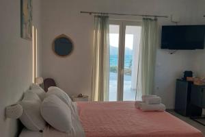 a bedroom with a bed with a view of the ocean at Bay-dream 3 in Adamantas