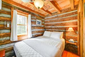 a bedroom with a bed in a log cabin at Dobson Vacation Rental - Close to Wineries! in Dobson