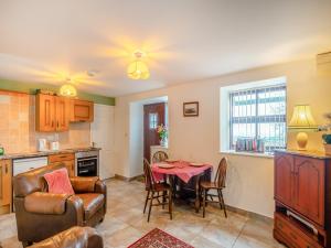 a kitchen and living room with a table and chairs at The Cottage - Uk43952 in Boosbeck