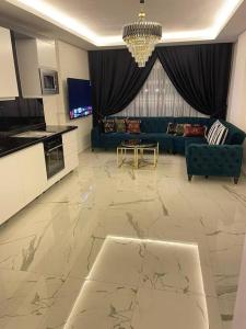 a large living room with a large marble floor at Fully furnished 1+1 apartment in luxury complex Heaven Hills in Mahmutlar