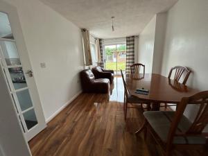 a living room with a dining room table and a couch at Ivydale Guest House in Syston +19 photos