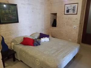 ein Schlafzimmer mit einem Bett mit Kissen darauf in der Unterkunft Casa Perosi in Noci