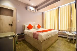 a hotel room with a bed and a window at Hotel Kanchan Residency in Kota