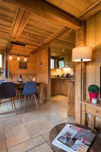 a kitchen with a table and a dining room at Le Mazot de Janton in Combloux