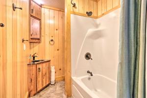 a bathroom with a white tub and a sink at Cozy Haven of Rest Home with Amish Country Views! in Shipshewana