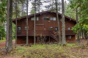 a building in the woods with trees at Escape To Ptarmigan Village 100 in Whitefish