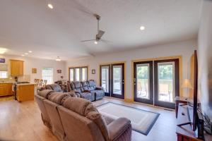 a living room with two couches and a kitchen at Waterfront Smith Mountain Lake Home with Boat Dock! in Moneta