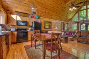 a kitchen and living room with a table in a cabin at Buckhead #259 in Sevierville
