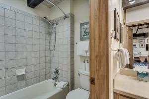 a bathroom with a toilet and a bath tub at Laurelwood Condominiums 411 in Snowmass Village +20 photos