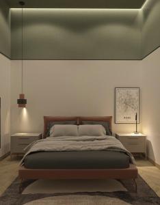 a bedroom with a large bed with a green ceiling at Salamina's apartments in Salamina