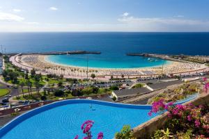 a view of a swimming pool and a beach at Gloria Palace Royal Hotel & Spa in Puerto Rico de Gran Canaria