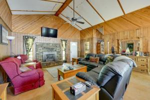 a living room with a couch and a fireplace at Rural Arkansas Vacation Rental with Lake Access in Scranton