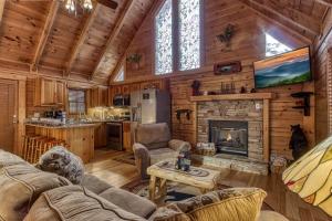un salon avec cheminée dans une cabane en rondins dans l'établissement Two-Bedroom House, à Pigeon Forge
