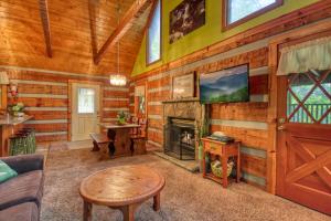 a living room with a fireplace in a log cabin at Parkside Party #1676 in Gatlinburg