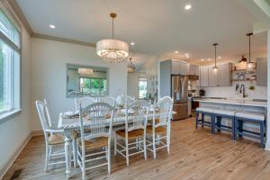 a kitchen and dining room with a table and chairs at Waterfront Maryland Vacation Home Private Beach! in Ridge