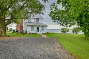 a white house with a tree and a driveway at Waterfront Maryland Vacation Home Private Beach! in Ridge