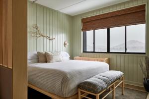 a bedroom with a large bed and a window at Bluebird Lake Placid in Lake Placid