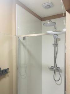 a shower with a glass door in a bathroom at Snuze Whitby in Whitby