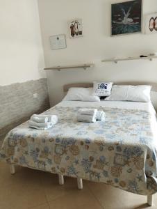 a bedroom with a bed with towels on it at Affitta Camere Zio Peppe in San Teodoro +31 photos