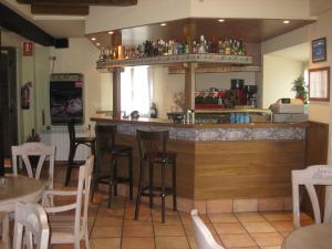 a kitchen that has a table and chairs in it at Hotel Rural Loizu in Burguete
