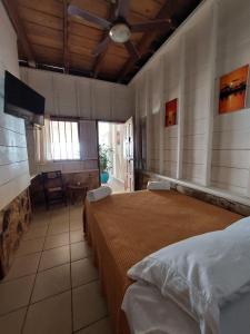 a large bedroom with two beds and a dining room at Sunset Bay B&B in Corn Island