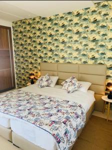 a bedroom with a bed and a wall with fish on it at Puerto marina in Asilah