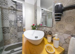 a bathroom with a white sink and a shower at Alfeo E Aretusa Apartment in Siracusa +22 photos