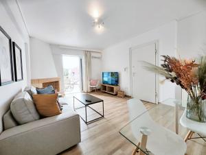 a living room with a couch and a table at Kalipsous by Verde Apartments in Athens