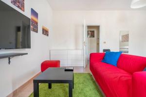 a red couch and a table in a living room at Casa Vacanze Visit Puglia in Casamassima