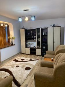 a living room with a couch and a rug at Vali Apart in Mangalia