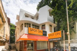 a building with a spot on sign in front of it at SPOT ON Harini Lodge in Chennai