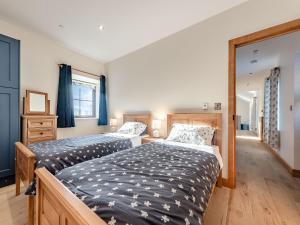 a bedroom with two beds and a window at Parlwr Godro - Uk41513 in Llanfair Clydogau