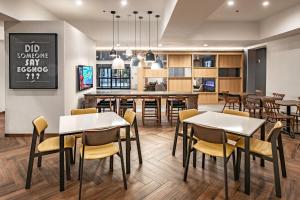 a dining room and kitchen with tables and chairs at Fairfield Inn & Suites Fort Worth Northeast in Hurst