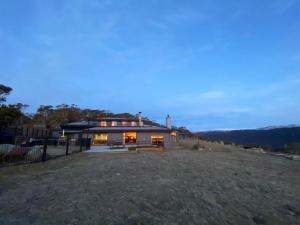 a house on top of a hill at dusk at Altitude 1260 in Jindabyne