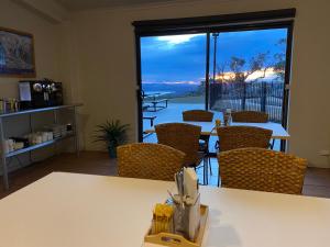 a living room with a table and chairs and a window at Altitude 1260 in Crackenback