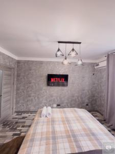 a bedroom with a bed with a sign on the wall at RentHouse Apartments Urban Lion in Chişinău