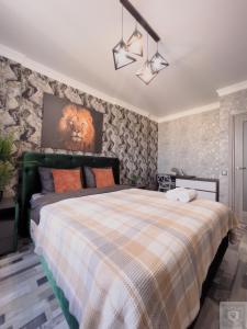 a bedroom with a bed with a lion head on the wall at RentHouse Apartments Urban Lion in Chişinău