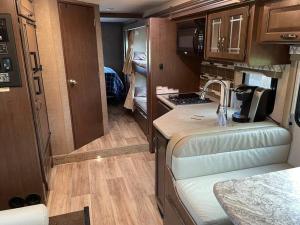 a small kitchen in an rv with a counter top at Quiet Country Rimrock Retreat RV in Hayden
