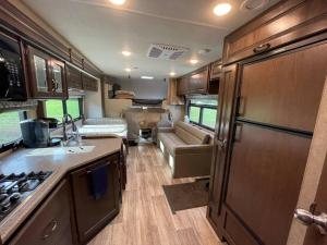 a kitchen and living room of an rv at Quiet Country Rimrock Retreat RV in Hayden