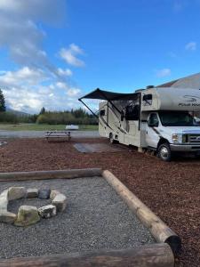 a white truck parked in front of a camper at Quiet Country Rimrock Retreat RV in Hayden
