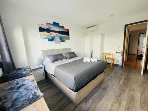 a bedroom with a large bed in a room at Beach Apartment Artigas in Badalona