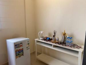 a white shelf next to a refrigerator in a room at استوديو في المدينة المنورة in Al Madinah