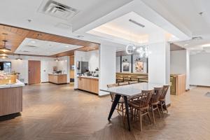 a dining room and kitchen with a table and chairs at Fairfield Inn & Suites by Marriott Hickory in Hickory