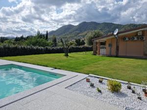 a backyard with a swimming pool and a house at Agriturismo Sa Jana Holidays - Adults Only in Cardedu