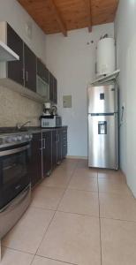 a kitchen with a stainless steel refrigerator and cabinets at Chesca- Piso de categoria in San Juan