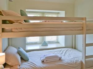 two bunk beds in a room with a window at Dragonfly Two in North Newton